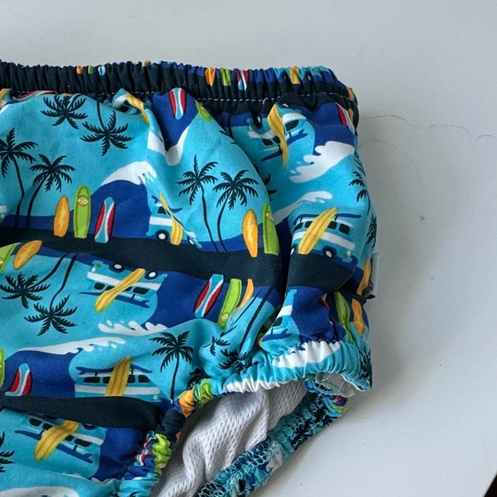 i play. Blue Surfboard and Palm Tree Swim Diaper